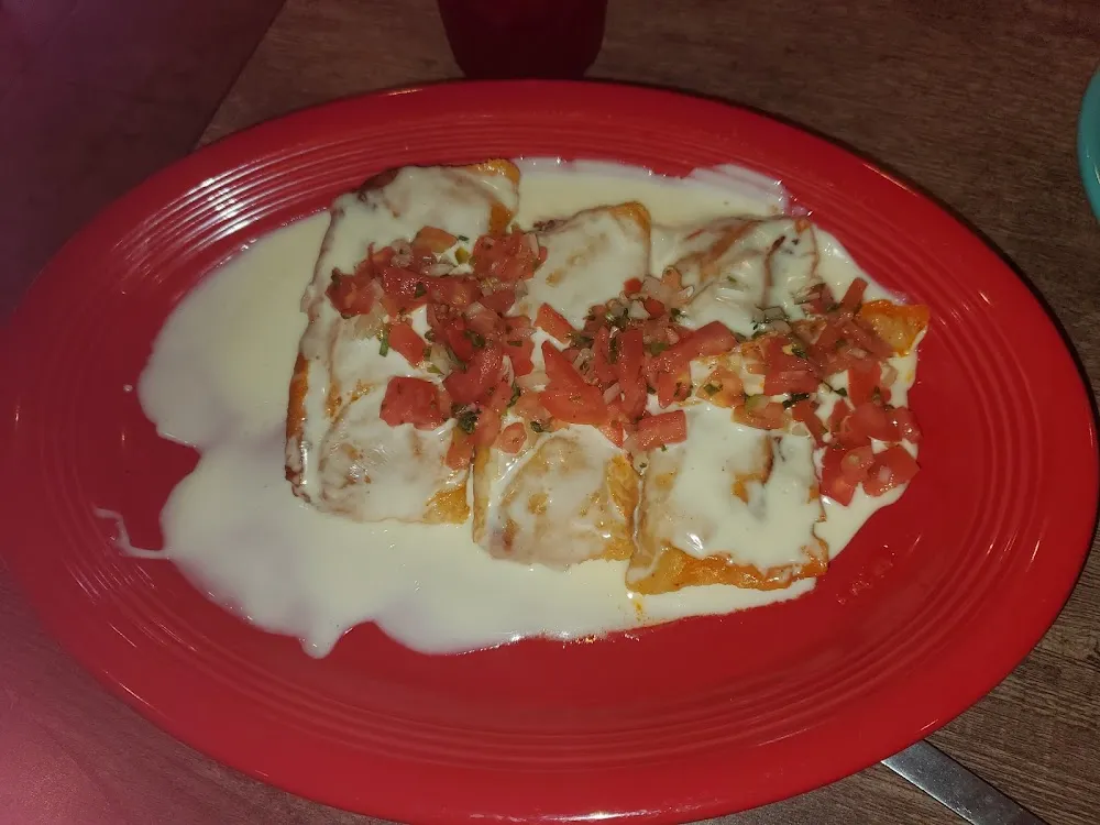 Tamale Plate Covered in Cheese Dip